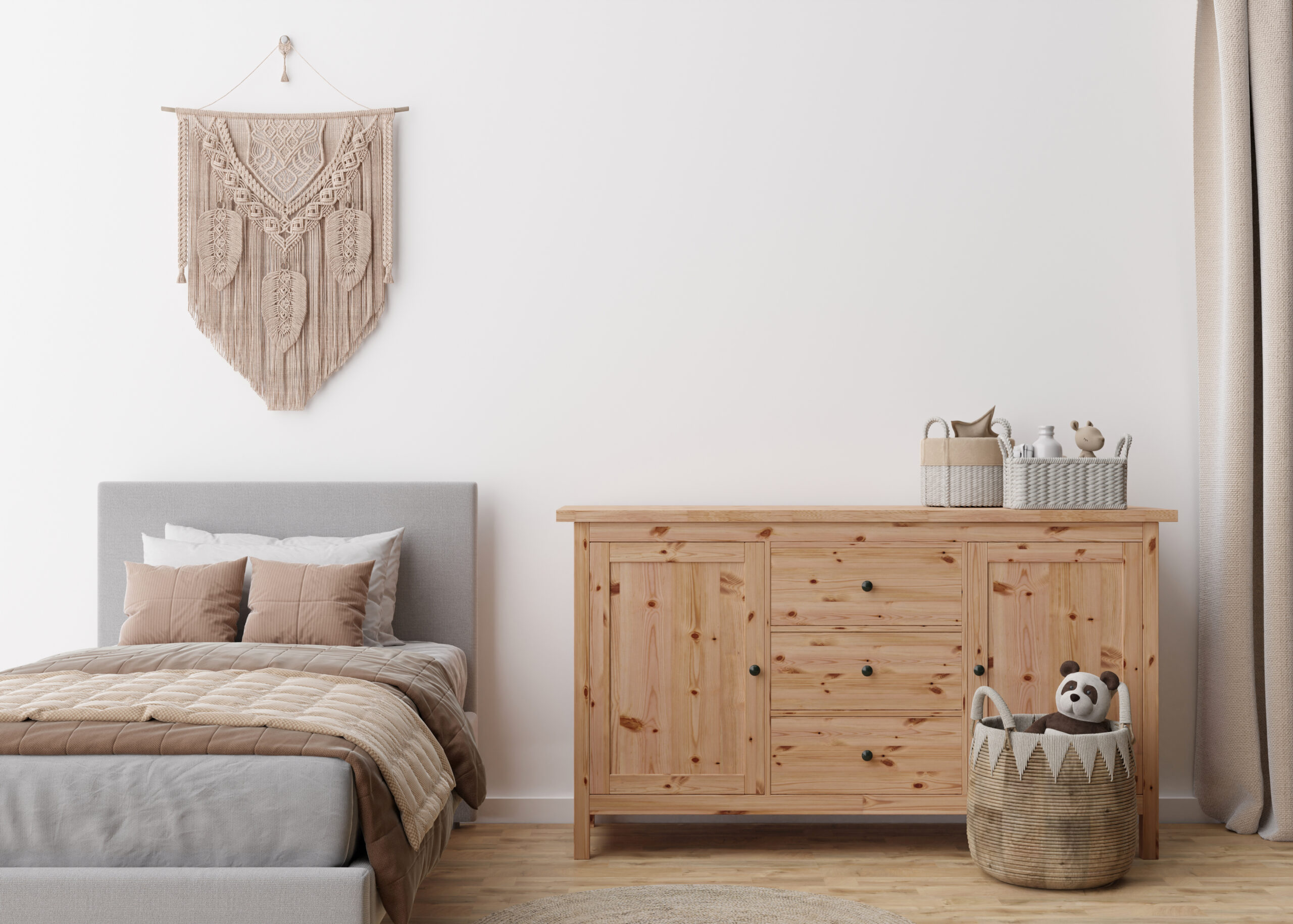 Empty white wall in modern child room. Mock up interior in boho style. Copy space for your picture or poster. Bed, toys, macrame wall decor, rattan basket. Cozy room for kids. 3D rendering